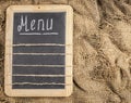 Restaurant menu. Top view of chalkboard menu laying on very old burlap background with copy space Royalty Free Stock Photo