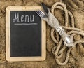 Restaurant menu. Top view of chalkboard menu laying on very old burlap background with copy space Royalty Free Stock Photo