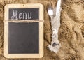 Restaurant menu. Top view of chalkboard menu laying on very old burlap background with copy space Royalty Free Stock Photo