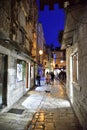 Restaurant in narrow streets of mediterranean city. Trogir at night. Croatia Royalty Free Stock Photo