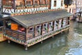 Restaurant in old buildings on stilts standing in river III in historical `Petite France` quarter of city of Strasbourg in France