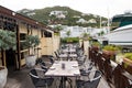 Restaurant open air in philipsburg, sint maarten. Terrace with tables, chairs and yacht in sea. Eating and dining outdoor. Summer Royalty Free Stock Photo