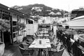 Restaurant open air in philipsburg, sint maarten. Terrace with tables, chairs and yacht in sea. Eating and dining Royalty Free Stock Photo