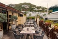 Restaurant open air in philipsburg, sint maarten. Terrace with tables, chairs and yacht in sea. Eating and dining Royalty Free Stock Photo