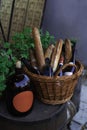 Restaurant patio still life vintage style wine bottle basket with baguette and another alcohol drink inside vertical photography