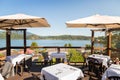 A restaurant patio with tables set overlooking Gibsons, BC, on a bright sunny day. Royalty Free Stock Photo