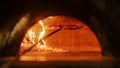 In Restaurant Pizza Peel Preparing Pizza into Wood Fire Stone Oven. Traditional Cooking, Italian Royalty Free Stock Photo