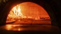 In Restaurant Pizza Peel Transferring Pizza into Wood Fire Stone Oven. Traditional Cooking, Italian Royalty Free Stock Photo