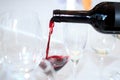 The process of pouring red wine from a bottle into a glass in a restaurant Royalty Free Stock Photo