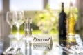 Restaurant reserved table sign with place setting and wine glasses ready for party