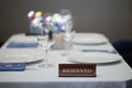 Restaurant reserved table sign with places setting and wine glasses ready for a party Royalty Free Stock Photo