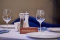 Restaurant reserved table sign with places setting and wine glasses ready for a party Royalty Free Stock Photo