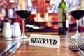 Reserved sign on restaurant table with bar background Royalty Free Stock Photo