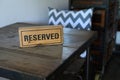 Restaurant reserved table sign Reserved Table. A tag of reservation placed on the wood table Royalty Free Stock Photo