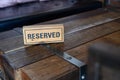 Restaurant reserved table sign Reserved Table. A tag of reservation placed on the wood table Royalty Free Stock Photo
