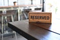 Restaurant reserved table sign Reserved Table. A tag of reservation placed on the wood table Royalty Free Stock Photo