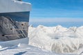 Restaurant or residential building on top of austrian alpine mountain peaks covered with snow layer in winter at bright cold Royalty Free Stock Photo