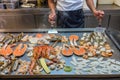 The restaurant`s chef cooking seafoods on big square pan in kitchen Royalty Free Stock Photo