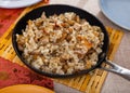 restaurant serves steamed pearl barley porridge with pork fried bacon and pickles, olives in pan