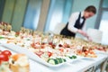 Restaurant waitress serving table with food Royalty Free Stock Photo