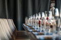 Restaurant serving and glass wine and water glasses, forks and knives on textile napkins stand in a row on a gray wooden table. C Royalty Free Stock Photo
