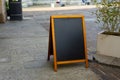 Restaurant sidewalk chalkboard sign board. Old Black Signboard on the street. Blank store signage sign design mockup