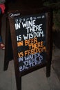 Restaurant sidewalk sign with funny quote about drinks in Warsaw, Poland