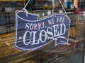A restaurant `Sorry, we`re closed` glass door sign.