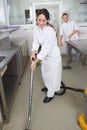 Restaurant staff cleaning kitchen floor