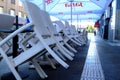 Restaurant street terrace early morning before opening with white patio chairs