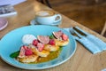 Restaurant sweet breakfast. Small pancakes with caramel cream and strawberries, figs, raspberries, fruit on top. a cup of a coffee Royalty Free Stock Photo