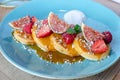 Restaurant sweet breakfast. small pancakes with caramel cream and strawberries, figs, raspberries, fruit  on top. Close up Royalty Free Stock Photo