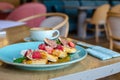 Restaurant sweet breakfast. Small pancakes with caramel cream and strawberries, figs, raspberries, fruit on top. a cup of a coffee Royalty Free Stock Photo