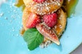 Restaurant sweet breakfast. Small pancakes with  cream and strawberries, figs, raspberries, fruit and meant on top. Close up Royalty Free Stock Photo