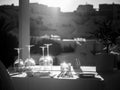 Restaurant table decorated with glasses on terrace in sunset light on the island Santorini Royalty Free Stock Photo