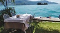 Restaurant table on a lawn on the shore of Lake Iseo in Montisola between Brescia and Bergamo in Italy Royalty Free Stock Photo