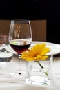 Restaurant table - Red wine and yellow flower Royalty Free Stock Photo