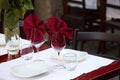 Restaurant table served outdoors for a couple. Two wine glasses with red napkins inside. Art of catering. New year red Royalty Free Stock Photo