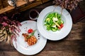 Two dishes on a wooden table - steak and salad. Set of food for lunch