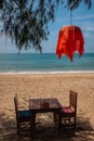 Restaurant table on a tropical beach with a red lantern Royalty Free Stock Photo