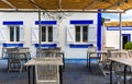 Restaurant tables with chairs on terrace near Praia da Rocha beach on coast of Portimao, Algarve, Portugal. Tables on terrace in