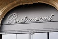 Restaurant text sign front of french building entrance in city street Royalty Free Stock Photo