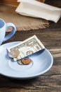 Restaurant tips in american banknotes and coins