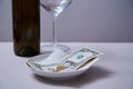 Restaurant tips or gratuity. Banknotes and coins on a plate