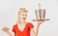 Restaurant waiter with champagne. Pinup girl with service tray. Serving presentation concept.