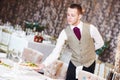 Restaurant waiter serving table with food Royalty Free Stock Photo