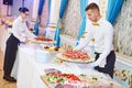 Restaurant waitress serving table with food Royalty Free Stock Photo