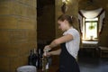 At a restaurant: waitress in uniform opening up bottles of wine