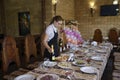 At a restaurant: waitress in uniform setting the table