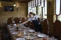 At a restaurant: waitress in uniform setting the table